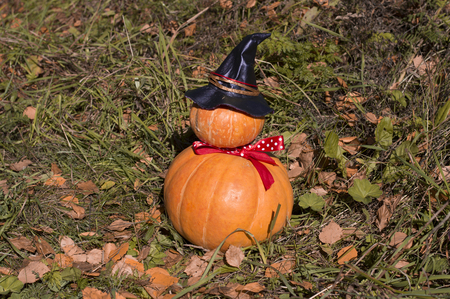 Funny pumpkins stacked as a man with a hatの写真素材