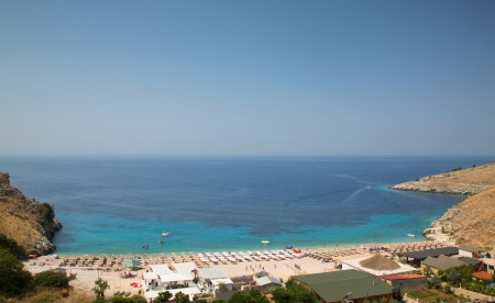 Coastal view of Albanian sea, with houses and wooden umbrellasの写真素材