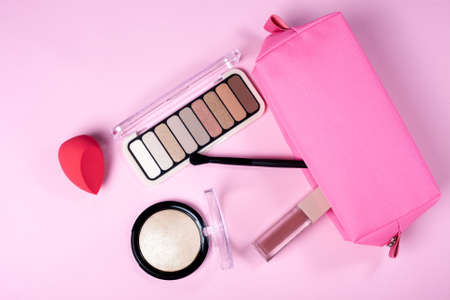 Set of decorative make up cosmetics on rose background. Flat lay with copy spaceの写真素材