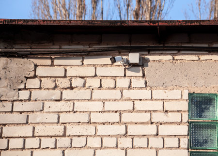 Security Camera, CCTV. Security camera on the brick wall. video surveillance system. Order maintenance in public placesの写真素材