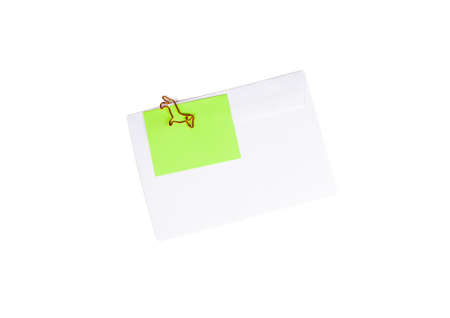 Paper envelope with blank note and dog-shaped paper clip on white background. Office supplies for a good mood. reminder on paper. Close upの写真素材