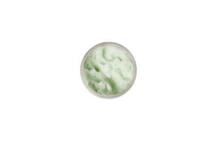 Texture cosmetic scrub for face and body in glass jar with white cap. Body scrub with green crystals. Isolated on white background. Top viewの写真素材