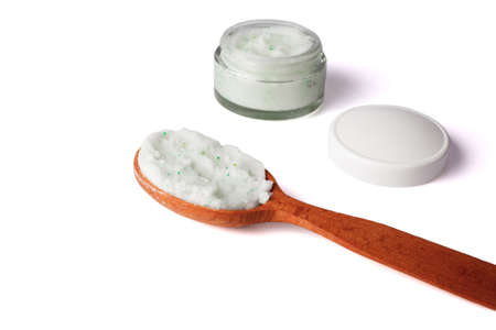 Body scrub with green crystals in wooden spoon. Homemade cosmetic for peeling and spa care. Isolated on white background.の写真素材