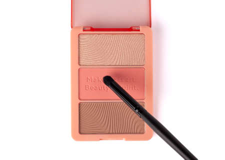 Set of nude pink and peach color eyeshadow in a palette with makeup brush isolated on white background. Highlighter and eyeshadows. Makeup product. Make-Up concept. Close upの写真素材