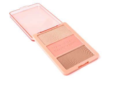 Set of nude pink and peach color eyeshadow in a palette isolated on white background. Highlighter and eyeshadows. Makeup product. Close upの写真素材