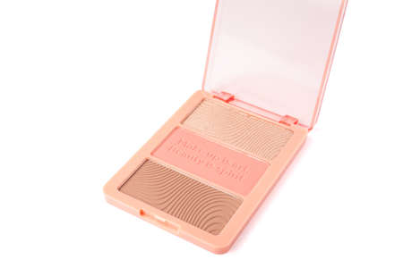Set of nude pink and peach color eyeshadow in a palette isolated on white background. Highlighter and eyeshadows. Makeup product. Close upの写真素材