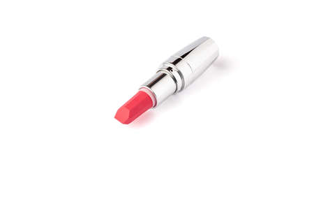 Red lipstick isolated on white background with copy space. Red lipstick in metallic shining case close up. makeup product macroの写真素材