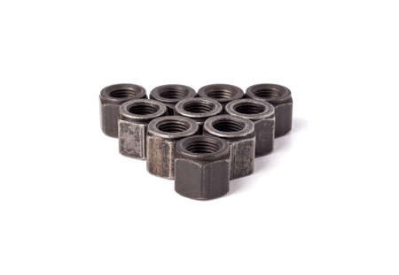 stack of metallic nuts isolated on white background. Heavy hex nut. Female screw nut with copy space. Fastenerの写真素材