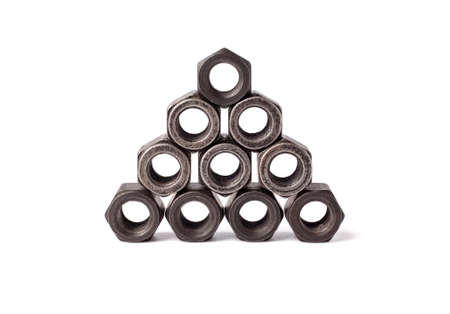 bunch of metallic nuts stacked in a pyramid isolated on white background. Heavy hex nut. Female screw nut with copy space. Fastenerの写真素材