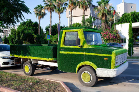 truck car decorated artificial green grass. Concept of energy saving, Sustainable transport, save ecologyの写真素材