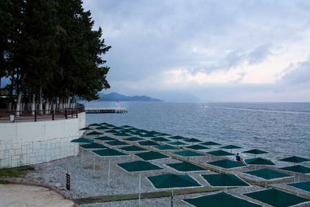 Beach with sunbeds, umbrellas on the mediterranean sea coast in Turkeyの写真素材