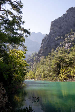 Lake with blue and green water is surrounded by rocks in canyon Goynuk, Kemer district in Antalya Province, Turkey. beautiful place for a hikeの写真素材