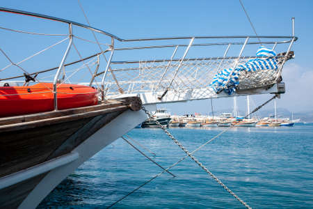 Many yachts and boats in the harbor. Ships on pier in port. Sea traveling. White pleasure yachts. Kemer, Turkey - 07.07.の写真素材
