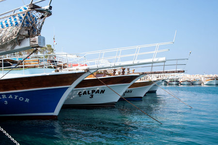 Many yachts and boats in the harbor. Ships on pier in port. Sea traveling. White pleasure yachts....