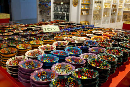 Colorful ceramic plates for sale in Turkey. Decorated tableware in the tourist store. souvenir. Kemer, Turkey - 07/08/2020の写真素材