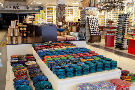 Traditional turkish tourist store at oriental bazaar. Decorated tableware in the souvenir store in Turkey. Souvenir. Kemer, Turkey - 07/08/2020の写真素材