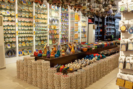 Traditional turkish tourist store at oriental bazaar. Decorated tableware in the souvenir store in Turkey. Souvenir. Kemer, Turkey - 07/08/2020の写真素材