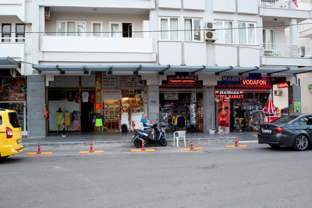View of the shopping tourist street. Street cafe and restaurant. Bored sellers souvenir in tourist store. Empty touristic shop. No tourists due coronavirus. Kemer, Turkey - 07/10/2020のeditorial素材
