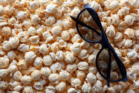 popcorn and 3 D glasses for watching a movie, popcorn background, movie time, place for textの写真素材