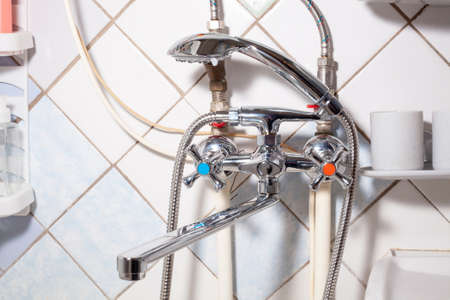 Chrome water faucet mixer tap in bathroom. Simple plumb equipment. shining mixer faucetの写真素材