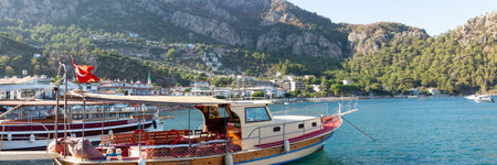 Sea bay surrounded by mountains and rocks in small touristic village Turunc. Panoramic view. Landscape with moored pleasure yacht. Turunc, Turkey - September 4. 2021のeditorial素材