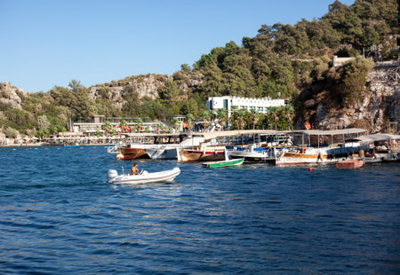 Sea bay surrounded by mountains and rocks in small touristic village Turunc. Landscape with moored pleasure yacht. Turunc, Turkey - September 4. 2021のeditorial素材