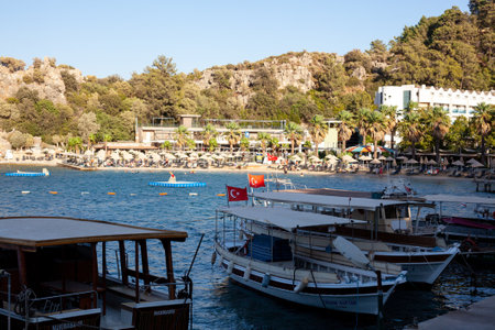 Sea bay surrounded by mountains and rocks in small touristic village Turunc. Landscape with moored pleasure yacht. Turunc, Turkey - September 4. 2021のeditorial素材