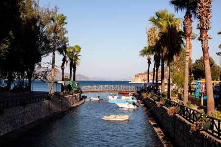 Motor boats moored at the water channel. Small fisher boat tied on river in small tourist village.の写真素材