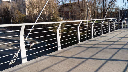 New pedestrian bridge with metal railings. Empty footbridge across the road.の写真素材