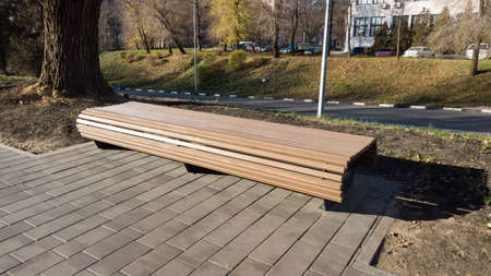 A modern bench without back in a city park on a sunny day. City improvement, urban planning, public spaces. Comfortable area for people.の写真素材
