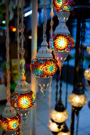 Traditional handmade multicolor Turkish, Moroccan, Arabian lamps. Mosaic style and colored glass lantern. Turkish lamps in souvenir shop in Turkeyの写真素材