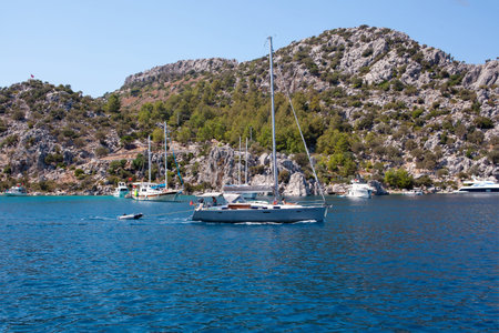 White sailing yacht moored in Aegean sea near Turkey coast. Luxury white boat yacht. Ships in sea. Sea traveling. View from boat. Marmaris, Turkey - September 9, 2022.のeditorial素材
