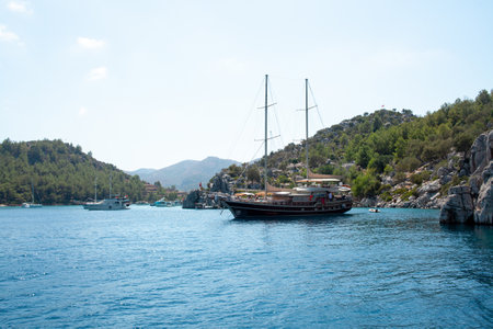 White sailing yacht moored in Aegean sea near Turkey coast. Luxury white boat yacht. Ships in sea. Sea traveling. View from boat. Marmaris, Turkey - September 9, 2022.のeditorial素材