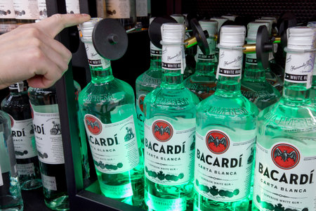 Bacardi rum for sale at a hypermarket. Buyer Hand holding Bacardi white rum. Ukraine, Kharkiv - May 27, 2023のeditorial素材