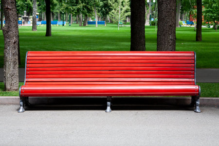 Red Wooden bench in the city park.の写真素材