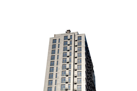 Multi-storey residential building isolated on white background. New building on construction site.