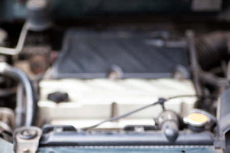 Get a glimpse under the hood of your car with this snapshot featuring engine components, hoses, and wires, an insiders view into the heart of automotive machinery.の写真素材