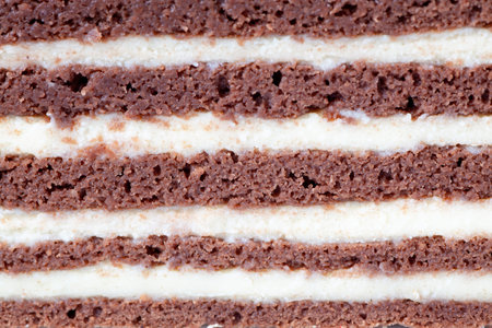 Close-up of a layered chocolate and cream cake, a tempting dessert with rich flavors and textures.の写真素材