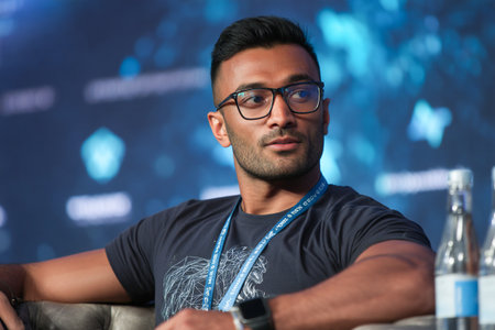 A tech expert engages with the audience, discussing important aspects of NFTs during a conference held in 2023. The atmosphere is focused and interactive.の素材