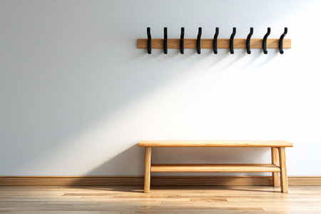 This home entrance features a sleek design with wooden coat hooks mounted on the wall above a simple bench, providing an organized space for coats and bags.の素材