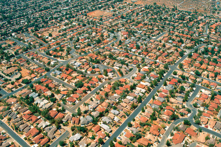 In this view of a residential neighborhood, homes are densely packed with winding streets creating a chaotic yet vibrant atmosphere.の素材