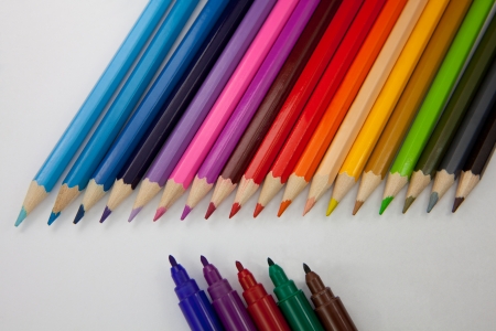 Sorted color pencils against sorted water color marker pens.の写真素材