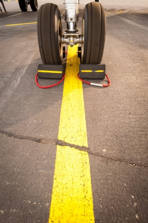 Airplane tires on yellow line, abstract transportationの写真素材