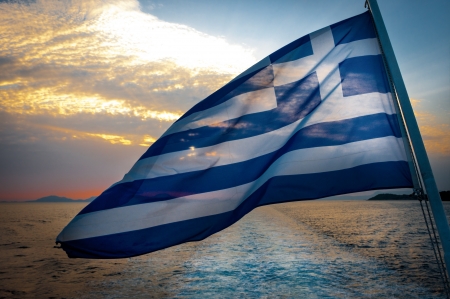 Greek Flag on boat in wind, dramatic skyの写真素材
