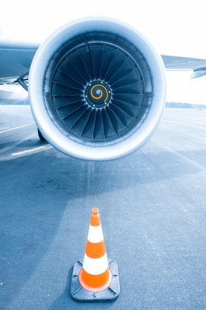 Jet engine with traffic cone in front, blue lightの写真素材