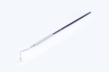 Tip of a dental probe on a real human extracted toothの写真素材