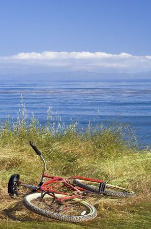 Red bike against ocean, California (USA)の写真素材