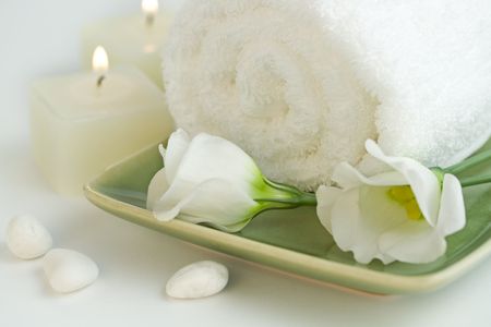 Spa setting with Beautiful white flowers, towel and candles. Time to relax.の写真素材