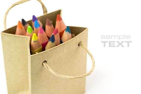 Color pencils in a shopping bag on a white backgroundの写真素材