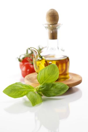 olive oil, basil and vegetables over whiteの写真素材